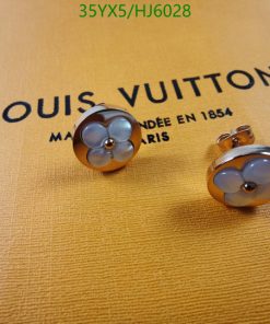 Designer cufflinks on branded packaging.