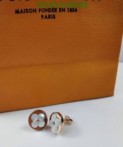 Elegant cufflinks with floral design before branded box.