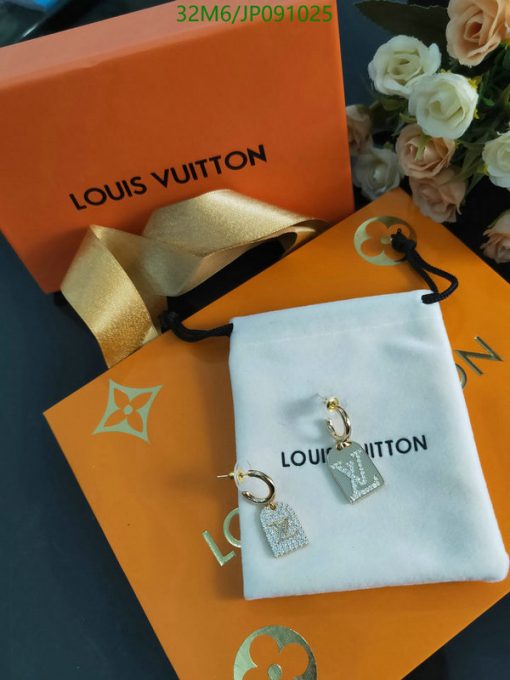 Louis Vuitton earrings on branded packaging with flowers.