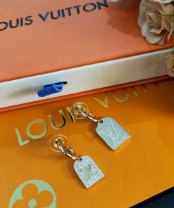 Luxury branded jewelry on orange packaging.