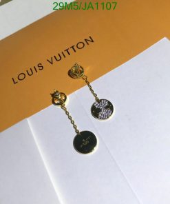 Designer dangle earrings on branded packaging.