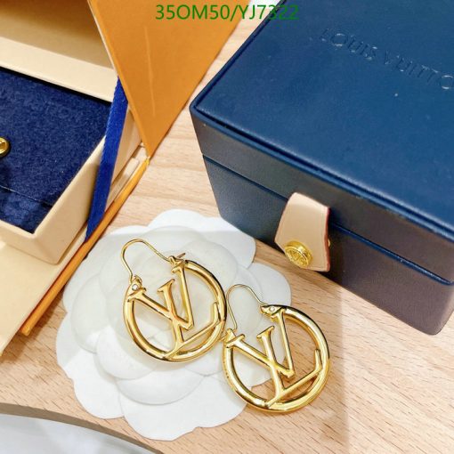 Designer gold hoop earrings on display with box