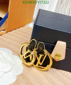 Gold-tone logo earrings on display with box.