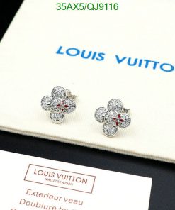 Designer flower-shaped earrings on branded display.