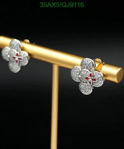 Diamond flower earrings on gold stand.