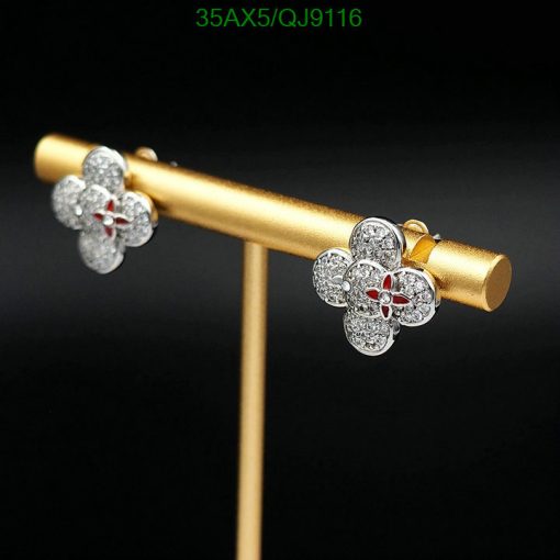 Diamond flower earrings on gold stand.