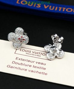 Louis Vuitton flower earrings on brand label.