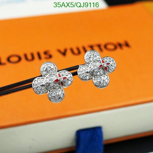 Sparkling flower earrings on designer box background.