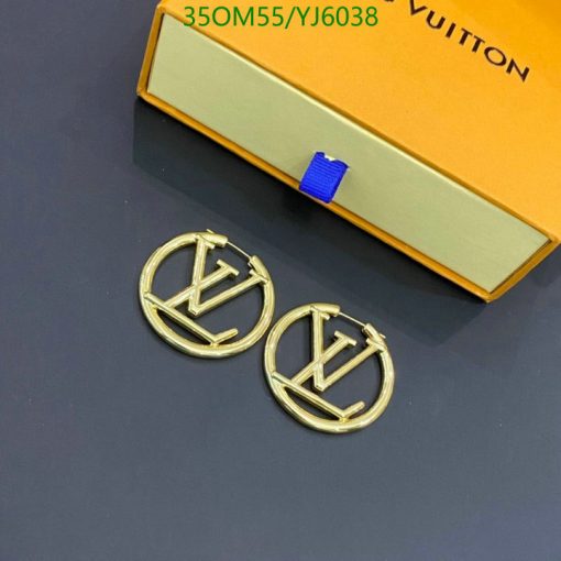 Designer brand logo earrings on table with box.