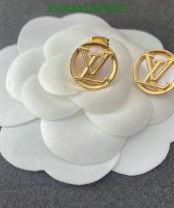 Designer earrings on white flower petals.