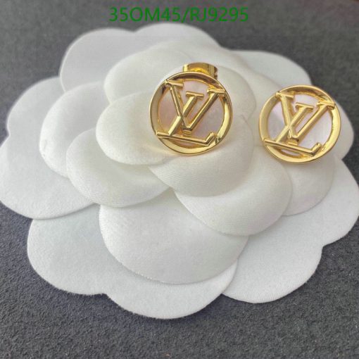 Designer earrings on white flower petals.