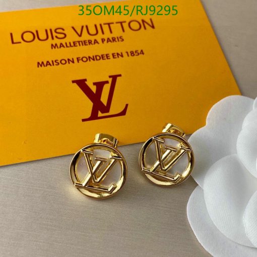 Gold designer cufflinks with brand card and white flower.