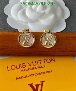 Gold Louis Vuitton cufflinks on branded box.