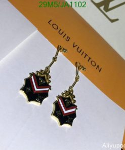 Designer star-shaped earrings on branded card.