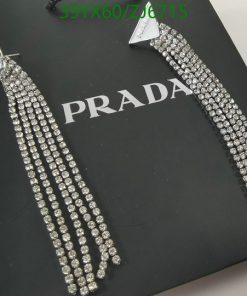 Long crystal tassel earrings on Prada box.