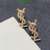 Gold diamond dollar sign earrings.