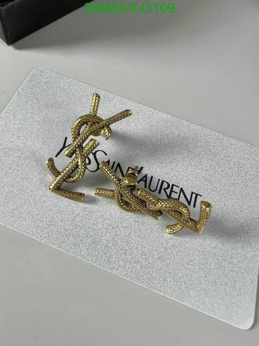 Gold designer logo earrings on white background.