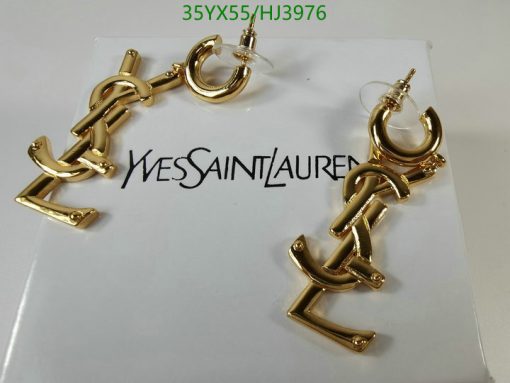 Gold anchor-shaped earrings on branded card.