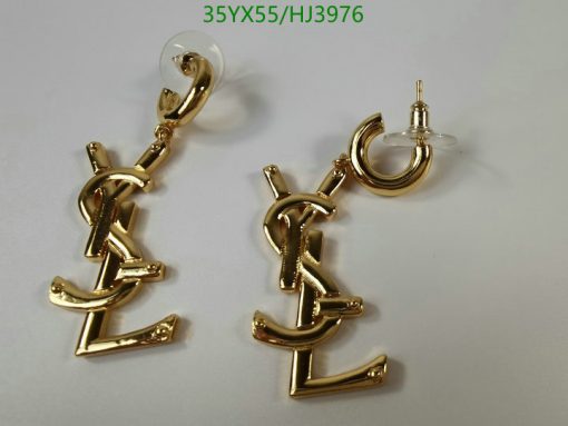 Gold-tone anchor-shaped dangling earrings on white background.