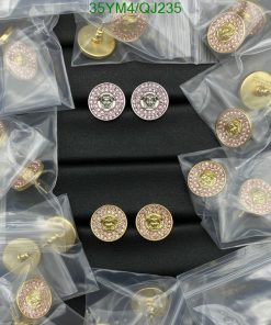 Decorative pink gemstone buttons on black surface.