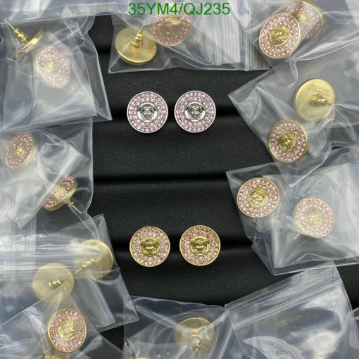 Decorative pink gemstone buttons on black surface.