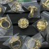 Gold jewelry pieces in transparent packaging.