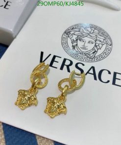 Gold designer earrings on branded box.