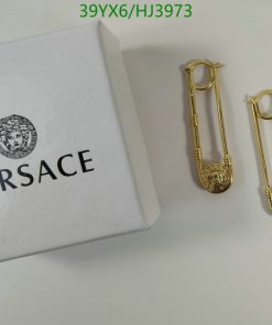 Versace box and pair of gold earrings.