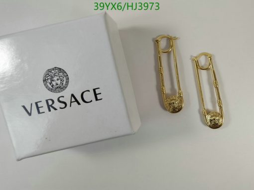 Versace box and pair of gold earrings.