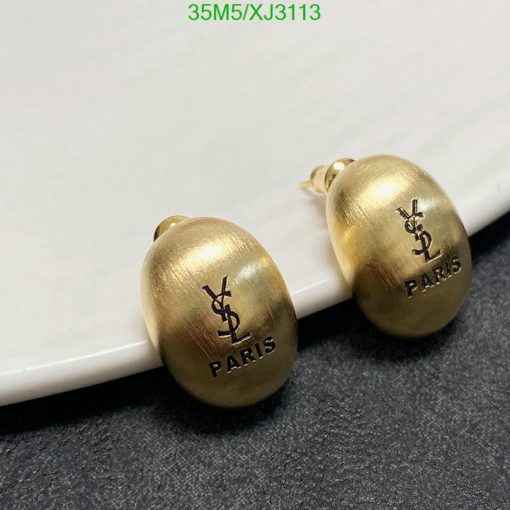 Gold designer logo earrings on white surface.