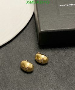 Saint Laurent gold bean earrings and box on table.