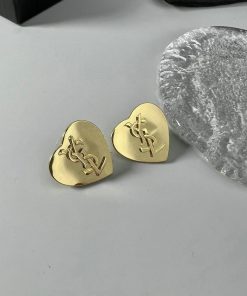 Gold guitar picks with emblem on table.