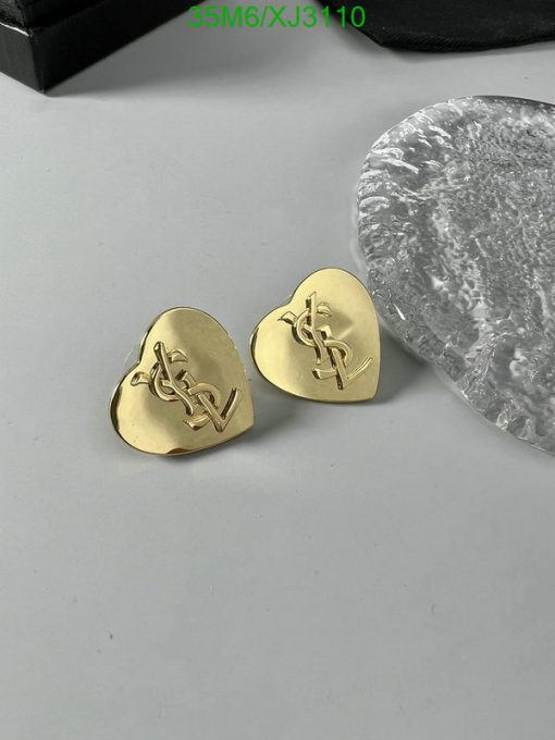 Gold guitar picks with emblem on table.