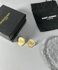 Saint Laurent earrings with box and pouch on white surface.