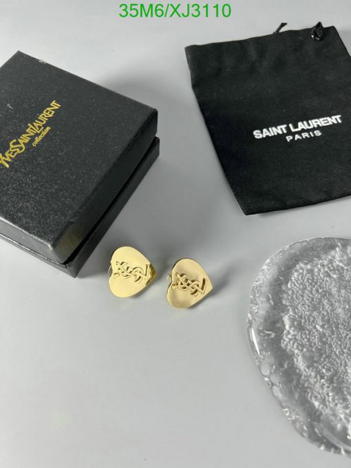 Saint Laurent earrings with box and pouch on white surface.