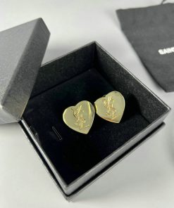 Gold heart-shaped earrings in black box.