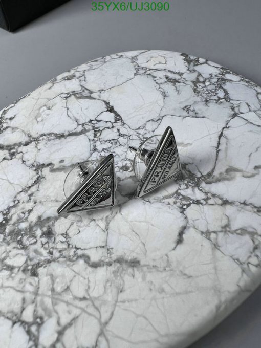 Silver cufflinks on marble surface.