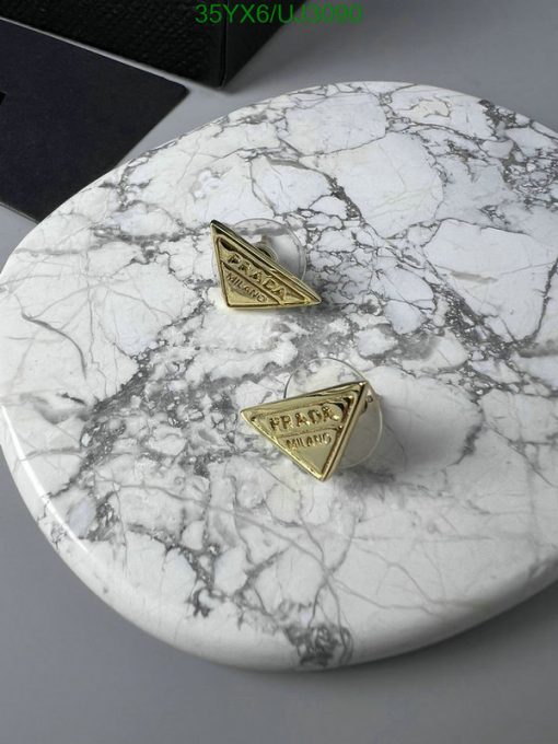 Designer cufflinks on marble surface.