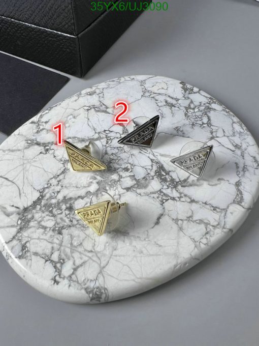 Designer cufflinks on marble background.