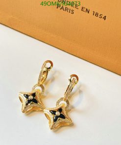 Gold star-shaped earrings on white surface