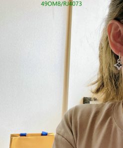 Person wearing star-shaped earring.