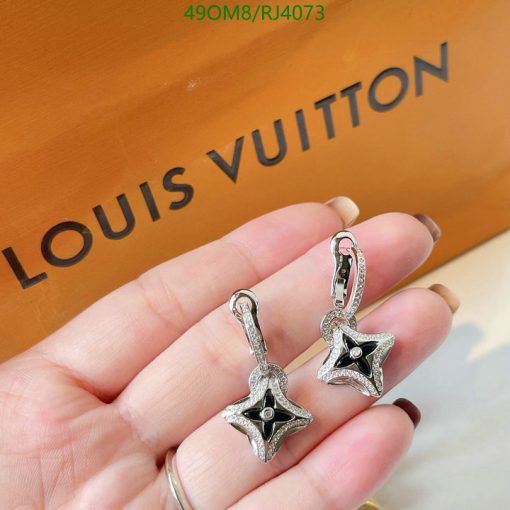 Star-shaped silver earrings with brand background