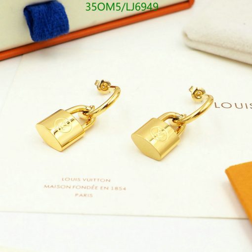 Gold padlock earrings on white display with branding.