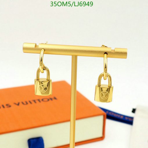 Designer lock-shaped earrings on display stand.