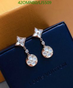 Star and flower pearl earrings on branded box