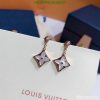 Star-shaped pendant earrings on white display.