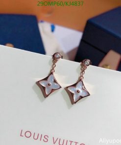 Star-shaped pendant earrings on white display.