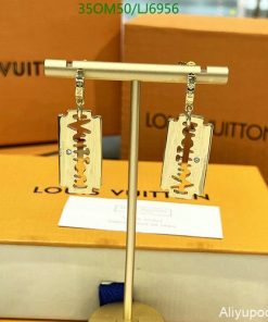 Louis Vuitton gold-tone razor blade earrings display on stand.