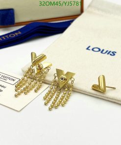 Gold tassel earrings on Louis Vuitton branded background