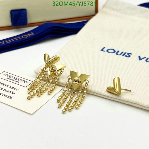 Gold tassel earrings on Louis Vuitton branded background